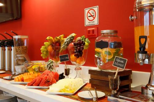 a buffet with cheese and fruit on a counter at Portofino Hotel in Teresina