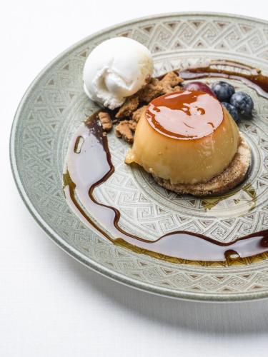 a plate of food with pancakes and blueberries and ice cream at Vincci Selección Unuk 5 GL in Seville