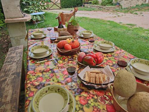 a picnic table with food and glasses of wine at Farmhouse in Apecchio with Pool and Terrace in Apecchio