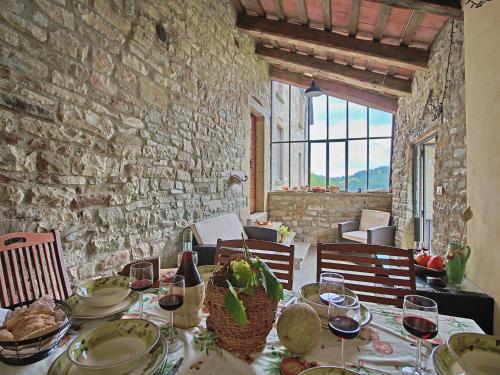a table with plates of food and wine glasses at Farmhouse in Apecchio with Pool and Terrace in Apecchio