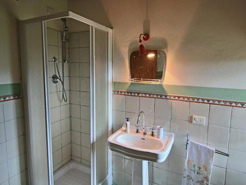 a bathroom with a sink and a shower at Farmhouse in Apecchio with Pool and Terrace in Apecchio