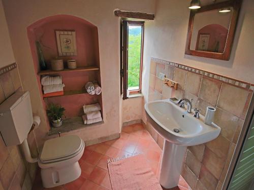 a bathroom with a sink and a toilet at Farmhouse in Apecchio with Pool and Terrace in Apecchio