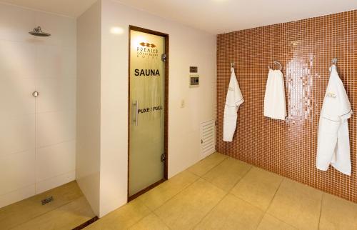 a dressing room with a green door in a brick wall at Premier Copacabana Hotel in Rio de Janeiro