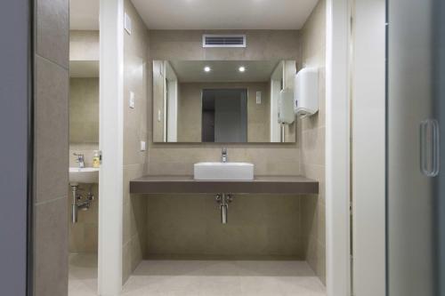 a bathroom with a sink and a mirror at Hotel Monaco in Caorle
