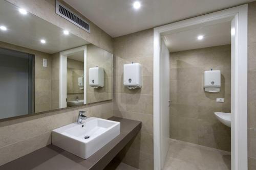 a bathroom with a sink and a mirror at Hotel Monaco in Caorle