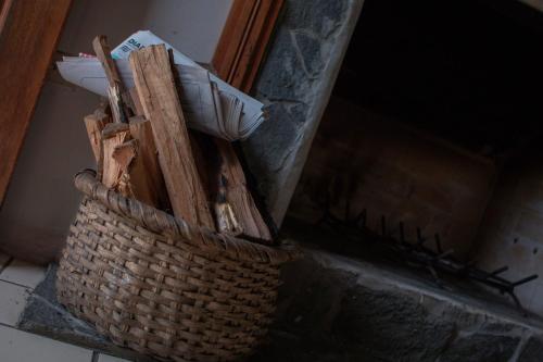 a basket filled with wood and other items at Hotel Villa Zurqui in San José