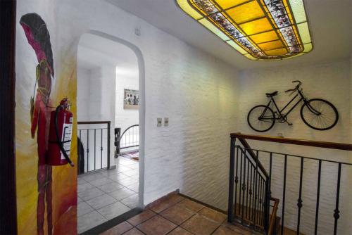 a bike hanging on the wall of a hallway at MedioMundo Hostel in Montevideo
