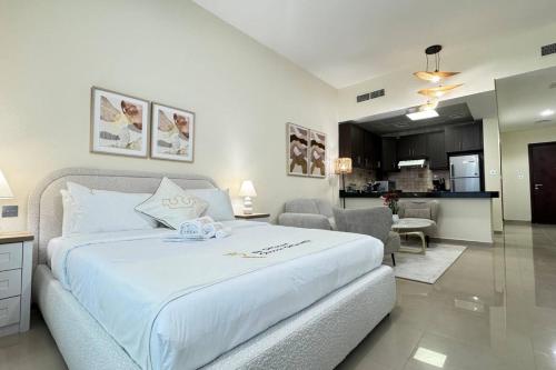 a bedroom with a large bed and a living room at 1BR Al Reem Island - Chic & Serene Luxe Retreat in Abu Dhabi