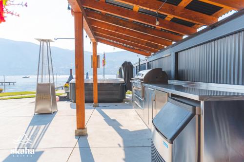 a outdoor kitchen with a grill and a view of the ocean at Skaha Suites in Penticton