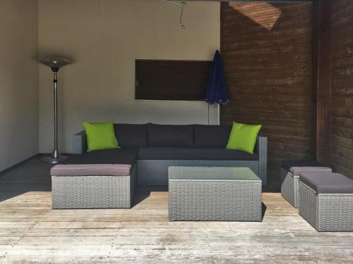 a living room with a couch and some green pillows at Modern Villa with Pool in Brives in Brives-sur-Charente