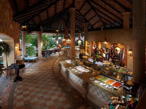 a restaurant with a buffet in a resort at Playa Grande Resort Optional All Inclusive in Cabo San Lucas