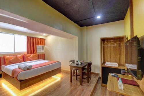 a bedroom with a bed and a table in it at Hotel Platinum Inn in Navi Mumbai