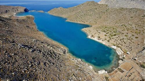 an aerial view of a blue lake on a mountain at Dorana Apartments & Trekking Hotel in Diafani