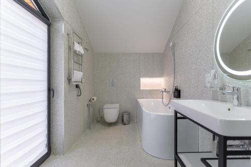 a bathroom with a sink and a toilet and a mirror at Phoenix Medical Resort in Skhidnitsa