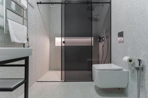 a bathroom with a shower and a toilet and a sink at Phoenix Medical Resort in Skhidnitsa