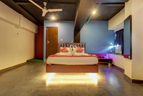 a bedroom with a bed with lights on the floor at Hotel Platinum Inn in Navi Mumbai