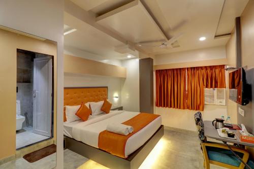 a bedroom with a bed and a desk in a room at Hotel Platinum Inn in Navi Mumbai