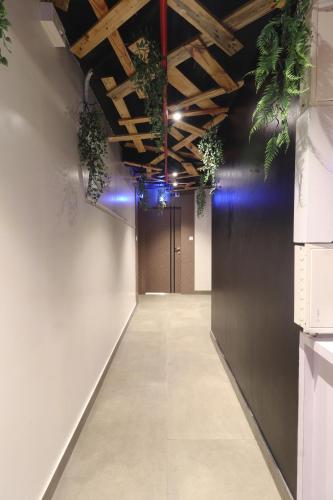 a hallway with potted plants on the ceiling at Hotel Platinum Inn in Navi Mumbai