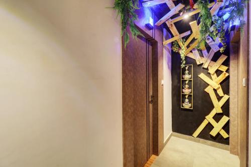 a hallway with a door and a wall with purple lights at Hotel Platinum Inn in Navi Mumbai