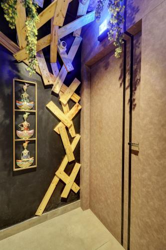 a room with a wall decorated with wooden crosses at Hotel Platinum Inn in Navi Mumbai