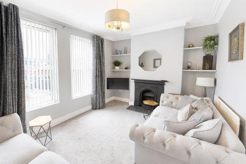 a living room with white furniture and a fireplace at Victorian House - South Belfast Lisburn Road - Northern Ireland Tourist Board Approved in Belfast
