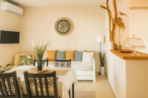 a bedroom with a bed and a table with chairs at Onde Dell' Etna 10 in Riposto