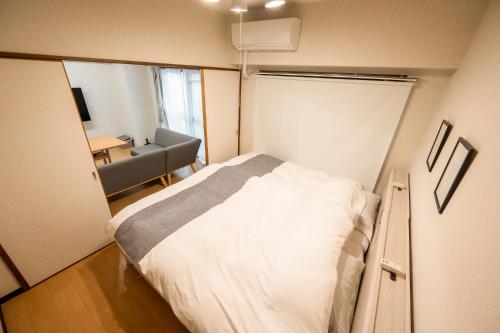 Postel nebo postele na pokoji v ubytování Ushamy's KOKURA STAY No 04