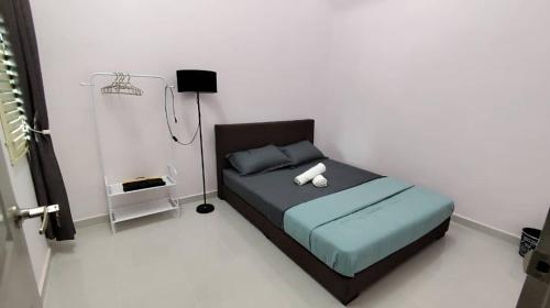 a bedroom with a bed in a white room at Adyan Homestay Terengganu in Bukit Payong