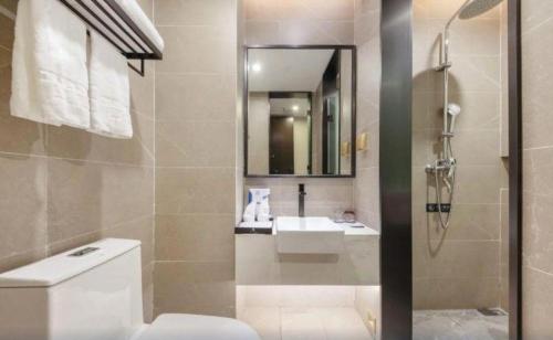 a bathroom with a toilet and a sink at H Life Hotel Nanshan Branch in Shenzhen