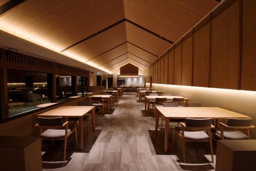 a row of tables and chairs in a restaurant at 山人 Oga in Oga