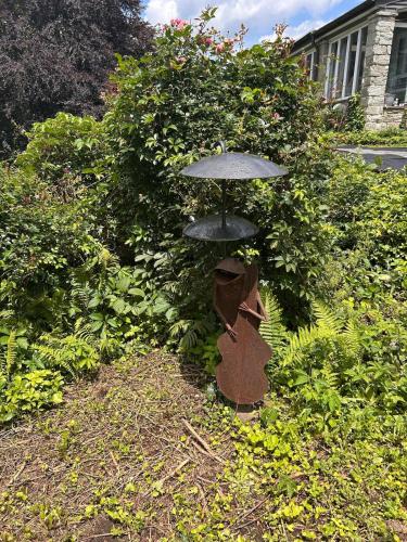 a statue of an umbrella in a garden at The Highland Oasis in Ephrata