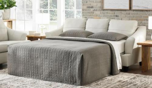 a bed in a room with a couch and a table at The Highland Oasis in Ephrata