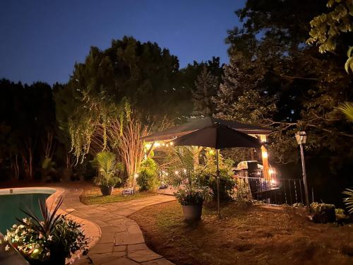 an umbrella in the middle of a garden at night at The Highland Oasis in Ephrata