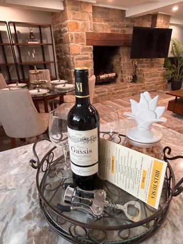 a bottle of wine on a table with a wine glass at The Highland Oasis in Ephrata