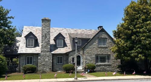 a stone house with a chimney on a street at The Highland Oasis in Ephrata