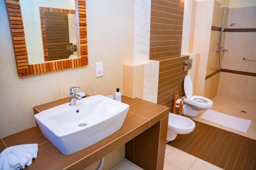 a bathroom with a sink and a toilet at Villa Vanilla in Port Glaud