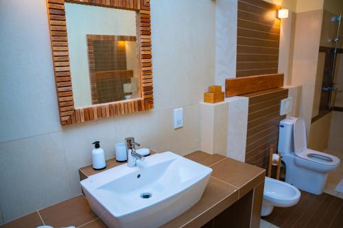 a bathroom with a sink and a toilet at Villa Vanilla in Port Glaud