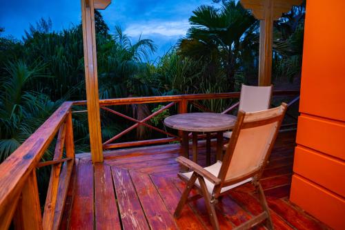 a wooden deck with a table and chairs on it at Villa Vanilla in Port Glaud