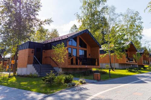 a house with a black roof on a street at Phoenix Medical Resort in Skhidnitsa