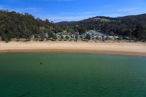 an aerial view of a beach with houses in the background at Ingenia Holidays Eden Beachfront in Eden