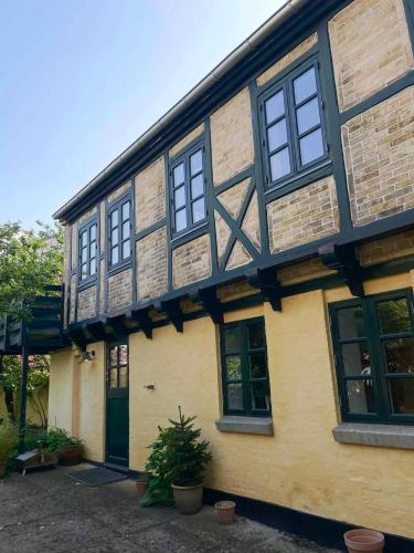 a building with black and yellow at Adventurous backhouse centrally located in Odense in Odense