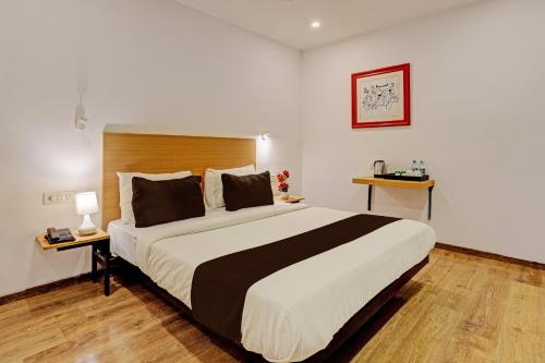 a bedroom with a large bed in a room at Super Townhouse Ramamurthy Nagar Formerly Navya International in Bengaluru