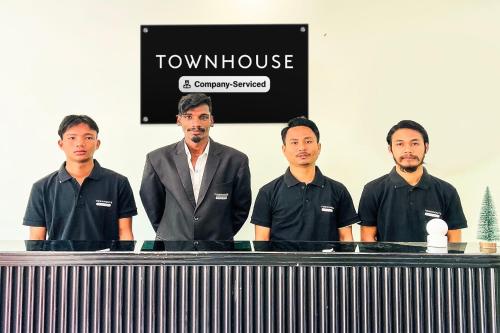 a group of men standing in front of a table at Super Townhouse Ramamurthy Nagar Formerly Navya International in Bengaluru