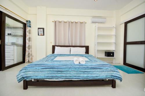 a bedroom with a bed with two towels on it at Babosam Apartments in Boracay