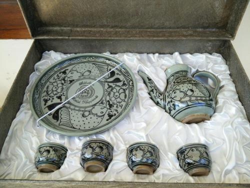 a box with a plate and a plate and a plate and a plate at Pottery Street House in Sukhothai