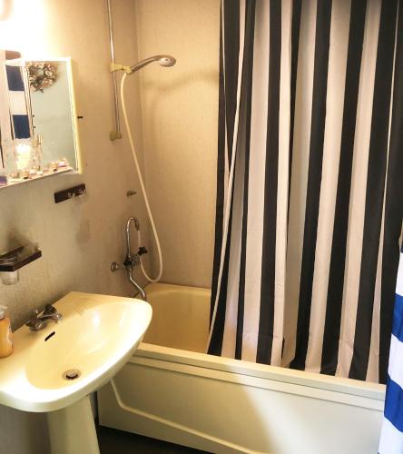 a bathroom with a sink and a shower curtain at Charming Holiday Home in Forest Idyll near Tosthult in Falsehult