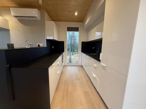 a kitchen with black and white counters and a window at Holiday home in the middle of nature in Knared in Eslared