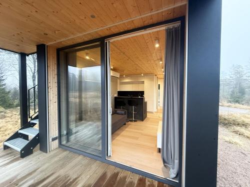 a glass house with a view of the living room at Holiday home in the middle of nature in Knared in Eslared