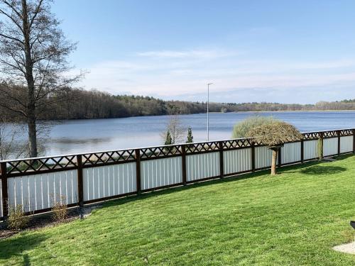 a fence in front of a body of water at Holiday home in Ronneby with swimming area and jetty in Ronneby