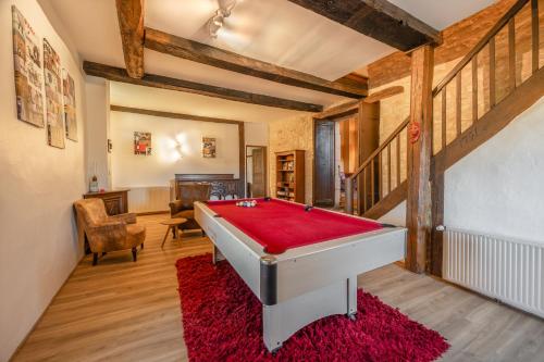 a pool table in a room with a red rug at Mas Combefa in Combefa